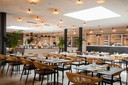 a restaurant with tables and chairs and a bar at Mangia's Brucoli, Sicily, Autograph Collection in Brucoli