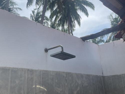 a sink on the side of a white wall at Kitekuda Kite Resort in Vannativillu