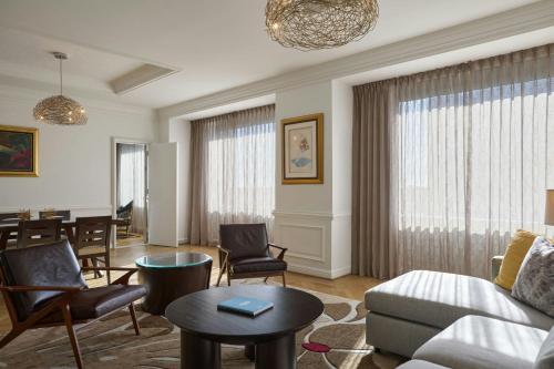 a living room with a couch and a table at The Henry, Autograph Collection in Dearborn