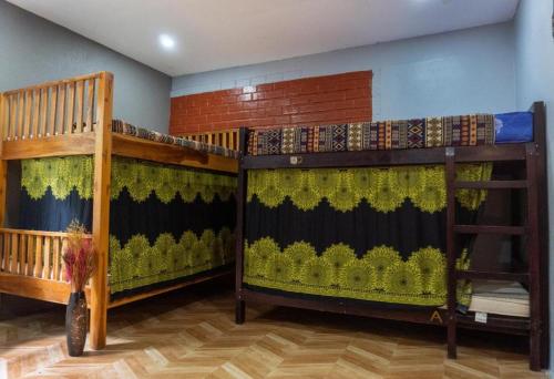 a room with two bunk beds in a room at La Casa De Jardin in Luang Prabang