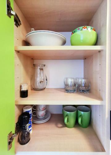 a cupboard with some bowls and dishes in it at Apartment Ennio in Povlja