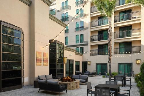 a courtyard with chairs and a fire pit in front of a building at Courtyard by Marriott Los Angeles Pasadena Old Town in Pasadena