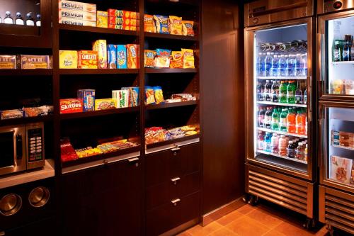 a kitchen with a refrigerator filled with lots of food at Courtyard Dayton South Mall in Miamisburg