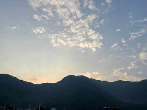 a view of a mountain range with the sun in the sky at Bipana's Homestay & Apartment in Kathmandu