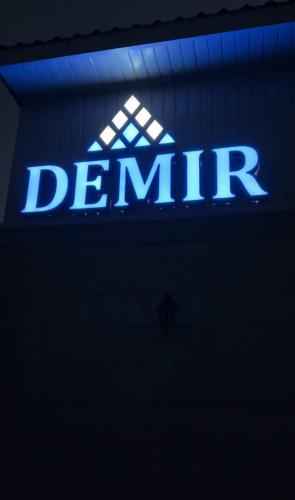 a blue sign that says dermination on a building at DEMIR Hotel in Taraz