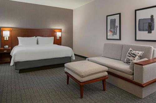 a hotel room with a bed and a couch at Courtyard Long Beach Airport in Long Beach