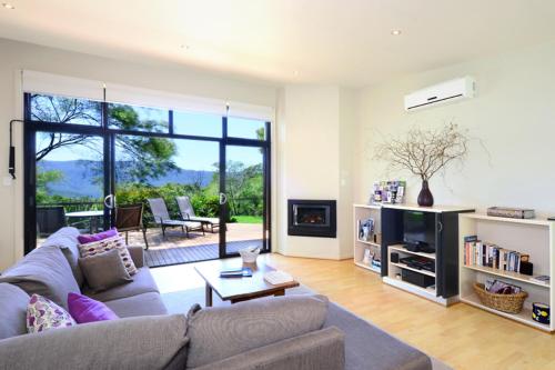 a living room with a couch and a table at The Heavens Mountain Escape in Kangaroo Valley