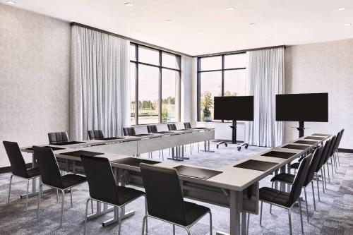 a conference room with rows of tables and chairs at AC Hotel by Marriott Bridgewater in Bridgewater
