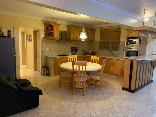 a kitchen with a table and chairs in it at Luxurious house at Coromandel in La Rotraite