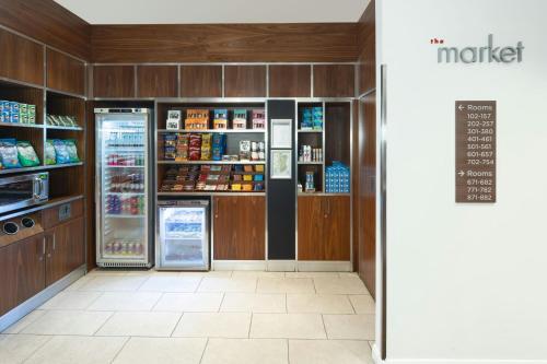 a grocery store aisle with a refrigerator and shelves at Courtyard by Marriott Edinburgh in Edinburgh