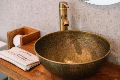 a sink with a faucet on a wooden counter at Anans Home Ha Giang - Tours & Motorbike Rental in Ha Giang