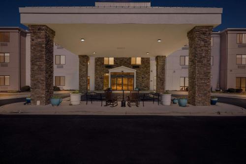 a building with tables and chairs in a courtyard at Comfort Suites Cullman I-65 Exit 310 in Cullman