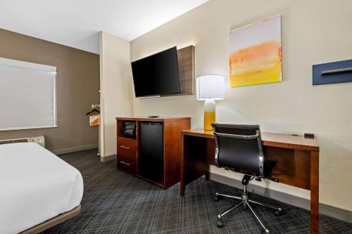 a hotel room with a desk with a bed and a computer at Comfort Suites Cullman I-65 Exit 310 in Cullman