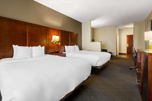 two beds in a hotel room with white pillows at Comfort Suites Cullman I-65 Exit 310 in Cullman