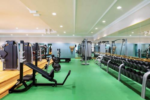 a gym with treadmills and machines at Sheraton Grand Doha Resort & Convention Hotel in Doha