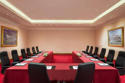 a conference room with a long table and chairs at Sheraton Grand Doha Resort & Convention Hotel in Doha