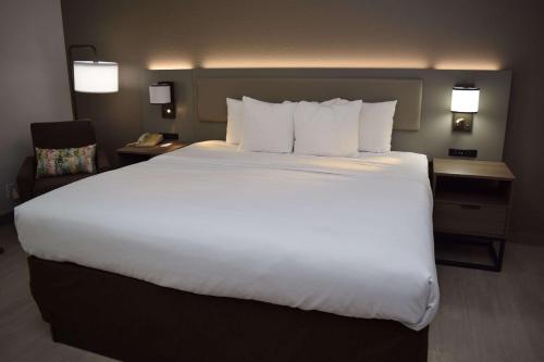 a large white bed in a hotel room at Comfort Inn & Suites Syracuse-Carrier Circle in East Syracuse