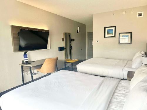 a hotel room with two beds and a flat screen tv at Comfort Inn & Suites Cartersville - Emerson Lake Point in Cartersville