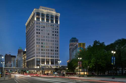 two tall buildings in a city at night at Hotel David Whitney, Autograph Collection in Detroit