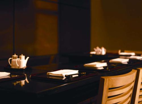 a black table with plates and napkins on it at Hilton Cairo Grand Nile in Cairo