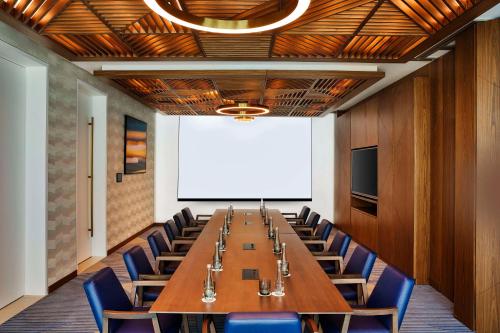 a conference room with a long table and chairs at Tumbi Hotel Dubai The Palm,Tapestry Collection Hilton in Dubai