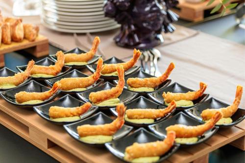 a bunch of trays of food on a table at Four Points by Sheraton Catania Hotel in Catania