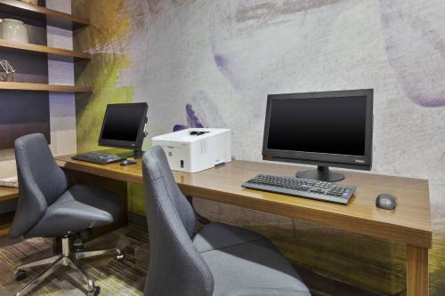 an office with a desk with a computer and two chairs at Courtyard by Marriott Secaucus Meadowlands in Secaucus