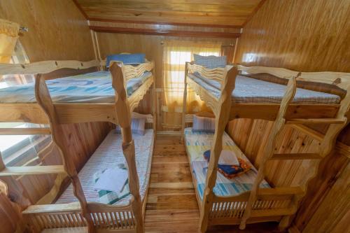 a room with three bunk beds in a cabin at Rice Homestay in Banaue