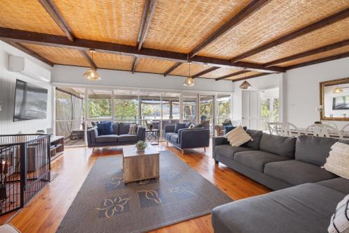 a living room with couches and a table at Paradise Retreat Lakehouse - Jamieson - Sleeps 10 in Jamieson