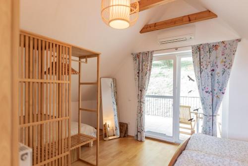 a room with a bed and a glass door at Winzerhaus Römerstrasse in Kitzeck im Sausal
