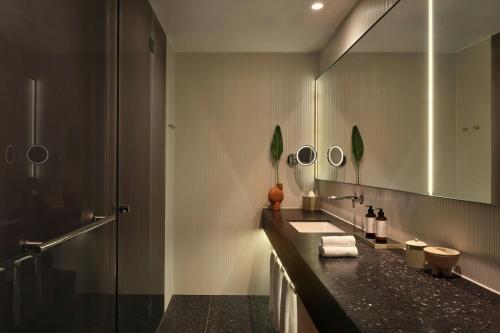 a bathroom with a sink and a shower at Dorothea Hotel, Budapest, Autograph Collection in Budapest