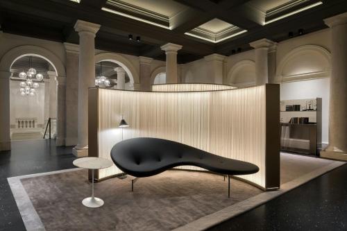 a black bench in a room with a table at Dorothea Hotel, Budapest, Autograph Collection in Budapest
