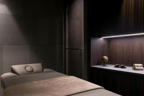 a bedroom with a bed and a table with a lamp at Dorothea Hotel, Budapest, Autograph Collection in Budapest