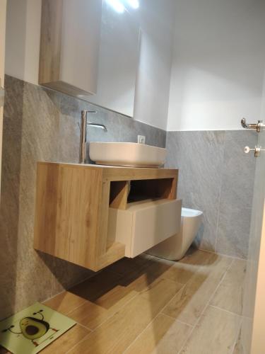 a bathroom with a sink and a toilet at Babahouse in Camerano