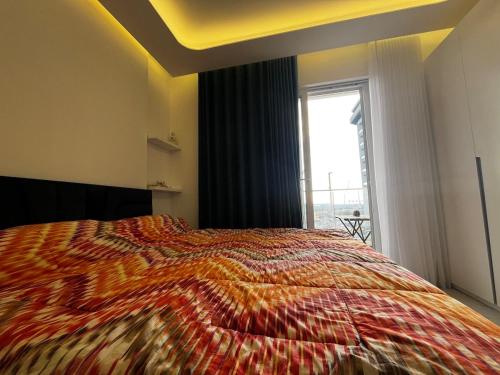a bedroom with a large bed and a window at Iris Apartment in Golem