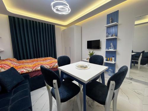 a bedroom with a bed and a table and chairs at Iris Apartment in Golem
