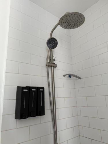 a shower with a shower head in a bathroom at Las Villas De La Serenidad in Calatagan