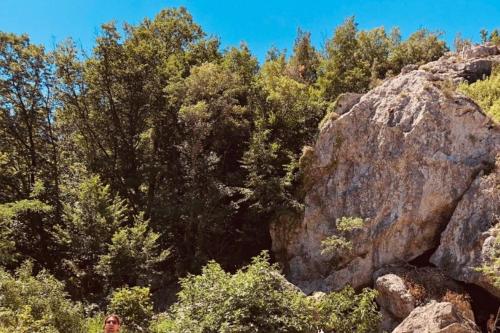 a person standing next to a large rock at La Casa di Lea in Santa Fiora
