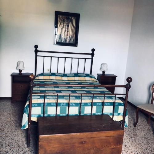 a bedroom with a bed with a wooden frame at La Casa di Lea in Santa Fiora