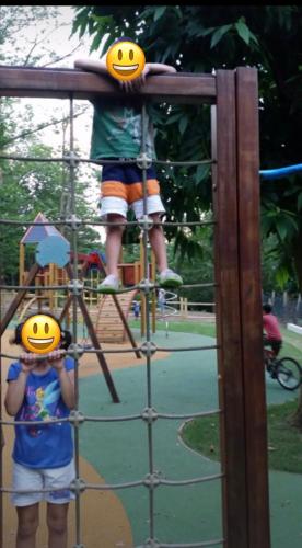 a young child is standing on a monkey bar at a playground at La Casa di Lea in Santa Fiora