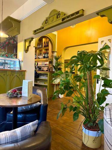 a restaurant with a table and a potted plant at The Old Hunting Lodge at The Talbot Inn in Tenbury