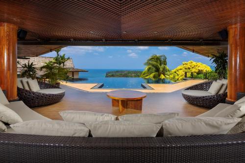 a living room with a view of the ocean at Luxury 4 pool Seaview 6 bedroom Villa on Surin Hill in Surin Beach