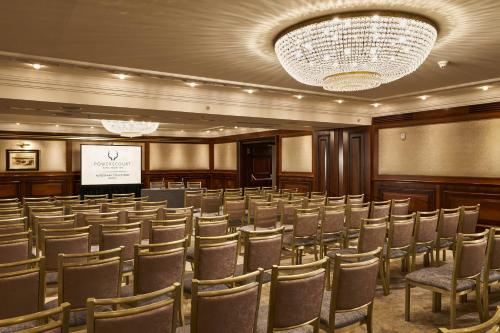 a conference room with a row of chairs and a screen at Powerscourt Hotel, Autograph Collection in Enniskerry
