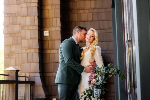 a bride and groom standing in front of a building at Grand Bohemian Lodge Greenville, Autograph Collection in Greenville