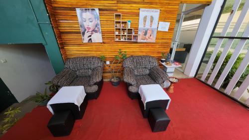 a balcony with two couches and a red carpet at One World Mirissa in Mirissa