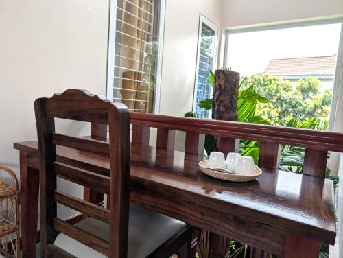a wooden table with a pair of shoes on a balcony at VILLA Siem Reap - eco & local in Siem Reap