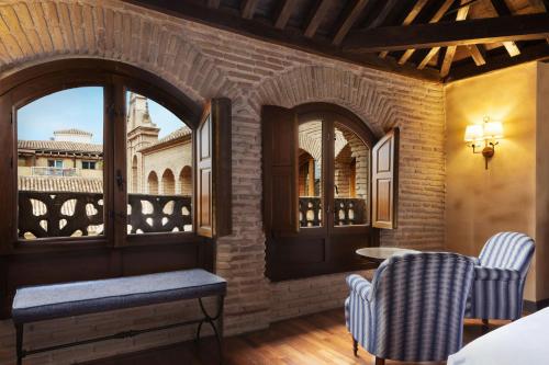 a room with a balcony with a view of the city at Hotel Palacio de Santa Paula, Autograph Collection in Granada