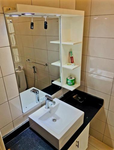 a bathroom with a sink and a mirror at Simba Villa in Arusha