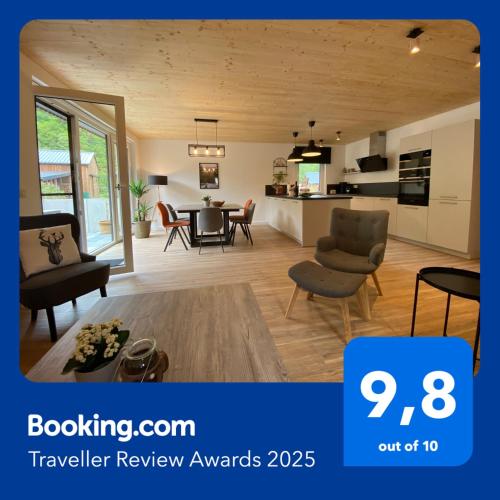 a large living room with a table and chairs at Waldblick - Holiday home with wellness in Ouren in Burg-Reuland