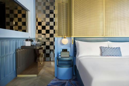 a bedroom with a blue bed and a table at W Budapest in Budapest